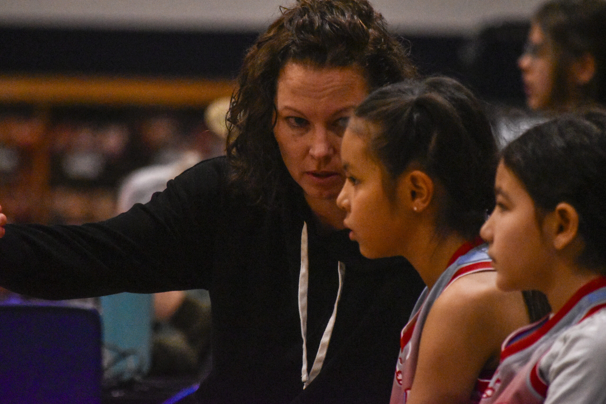 coach providing game time advice on the bench